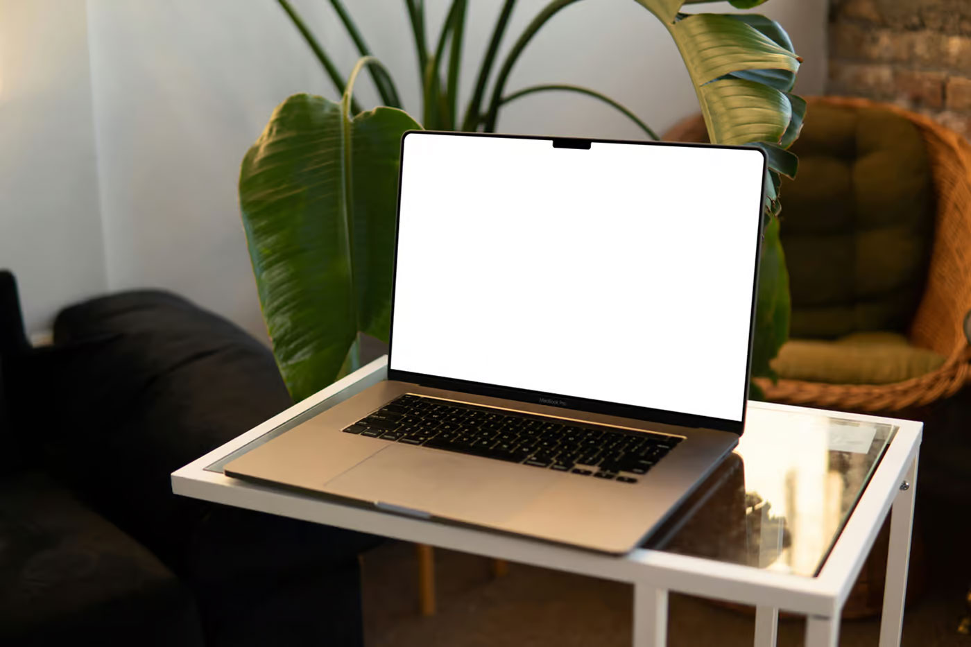 Free MacBook Pro on Small Table Mockup PSD Template