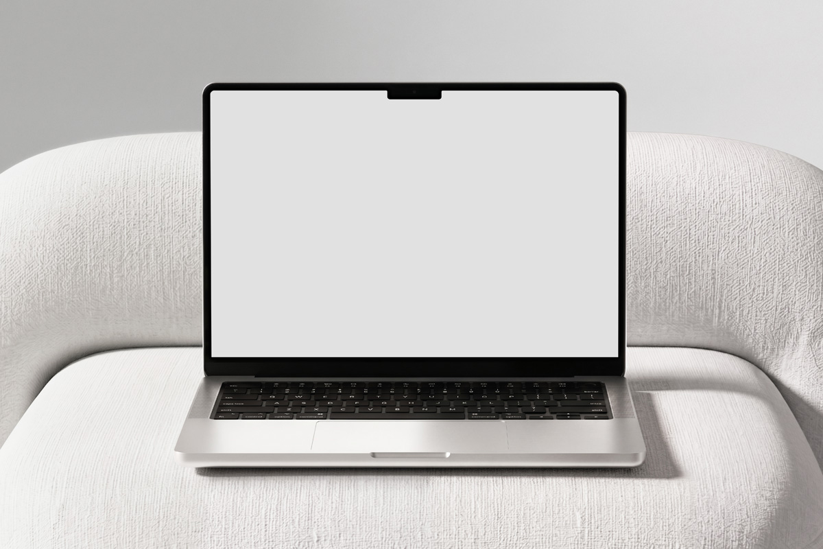 Free MacBook Pro on Sofa Mockup PSD Template